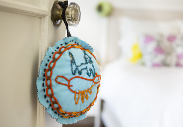 Rebecca Ringquist leads this children's craft project while she teaches you how to draw this fabric design. In this craft for kids project learn how to use stitches to translate a drawing into a craft project for children.