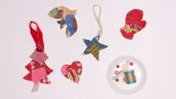 An overhead image of five fabric scrap ornaments, plus a small dish holding a needle, thread, and beads.