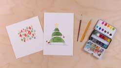 Two watercolor paintings, one of a whimsically-styled Christmas tree and one of a forest of trees and mushrooms, both from Maria Carluccio's Celebrate the Season Daily Holiday Painting Practice class on Creativebug.