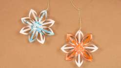Two woven paper stars, one cream and teal, one cream and orange, from Dawn M. Cardona's Creativebug class 