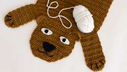 An brown-colored crocheted rug in the shape of a bear, made from Twinkie Chan's Crochet a Wild Animal Rug class on Creativebug