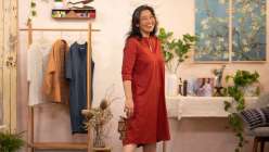 Sanae Ishida wearing a red tunic dress on the set of her Draft and Sew a Banded Collar Dress and Button-Down class on Creativebug