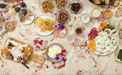table full of fall fruits and boards and plates of cream cheese with herbs and salts