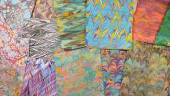A selection of marbled paper from Mercedez Rex's Creativity Through Marbling daily practice class on Creativebug
