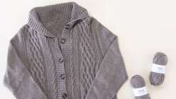 A grey knit sweater made by Tian Connaughton in her Knit the Freeport Cardigan class on Creativebug