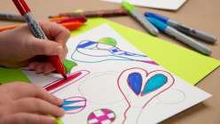 An image of a pair of hands coloring in outlines of craft scissors from Abby Houston's Creativebug Class Little Artists: A Course for Parent and Child
