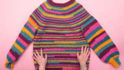 A colorfully striped sweater made in Twinkie Chan's Design and Crochet a Top-Down Bobble Sweater class on Creativebug.