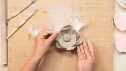 An unpainted flower made by Cindy Willingham's in her Make a Peony with Air-Dry Clay class on Creativebug.
