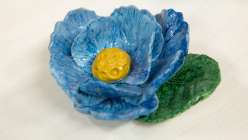 A blue peony flower made in Cindy Willingham's Make a Peony with Air-Dry Clay class on Creativebug.