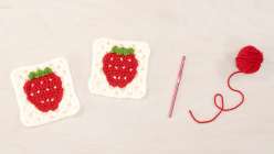 Two granny square made by Twinkie Chan in her Crochet a Strawberry Granny Square class on Creativebug