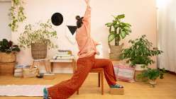 Liza Laird performing a supported yoga posture in her Movement for Makers class on Creativebug