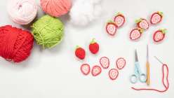 A few balls of yarn and in-progress strawberry slices made in Twinkie Chan's Crochet Cakery Daily Practice class on Creativebug.