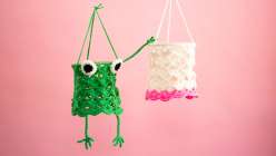 A green frog crocheted lantern and a white and pink crochet made by Twinkie Chan in her Crochet Home Decor: Make Hanging Lanterns class on Creativebug.