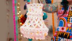 A white crocheted lantern made by Twinkie Chan in her Crochet Home Decor: Make Hanging Lanterns class on Creativebug.