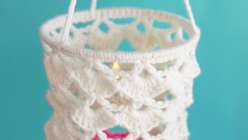 Detail of a white and pink crocheted lantern made by Twinkie Chan in her Crochet Home Decor: Make Hanging Lanterns class on Creativebug.