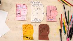 Six miniature paperback books in the shape of a face made by Suzy Ultman in her Creativebug class Sustainable Play: Make a Book About Me.