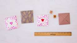 Four completed Valentine's Day-themed folded Victorian puzzle purses made in Courtney Cerruti's Make a Victorian Puzzle Purse class on Creativebug.