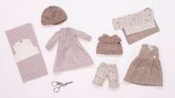 A dress, a sweater, a pinafore, a knit hat, and a pair of shorts, made by Katia Ferris in her Sew a Wardrobe for a 14-Inch Rag Doll class on Creativebug.