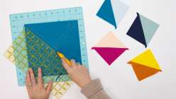 Faith Hale cutting a square of fabric in her How to Batch Cut Half Square Triangles class on Creativebug