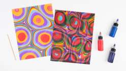 An example each of a marbled piece of paper and an overmarbled piece of paper from Mercedez Rex's Overmarbling On Paper class on Creativebug.