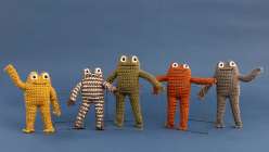 A family of crocheted frog toys made by Twinkie Chan in her Crochet a Posable Frog class on Creativebug