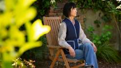 Mimi Shim wearing a denim vest she made in her Sew a Denim and Sherpa Vest class on Creativebug