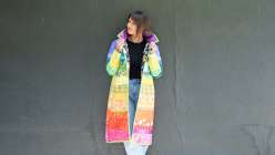Taiga from House of Taiga modeling a vibrant, handcrafted jacket made in her Rainbow Gradient Quilted Coat class on Creativebug.