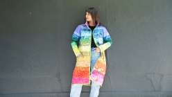 Taiga from House of Taiga modeling a vibrant, handcrafted jacket made in her Rainbow Gradient Quilted Coat class on Creativebug.
