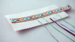 Rebecca Ringquist teaches making a vintage-inspired needle case. You'll learn to work with cotton, felt, and ribbon, improving sewing machine skills.