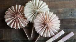 Lia Griffith teaches you how to make scalloped, frilly paper fans that are perfect for a diy wedding or backyard party project. Learn a fold-up version made with a Cricut Explore cutting machine or hand paper crafting.