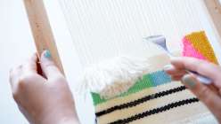 In this weaving class Annabel Wrigley teaches you how to build your own loom using an inexpensive frame and nails, and then demonstrates how to set up the warp threads.