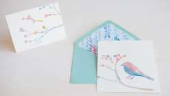 How to Make Watercolor Holiday Cards: Courtney Cerruti teaches how to create holiday motifs using watercolor and brushstrokes, how to use a stencil to apply watercolor,  how to make handmade cards.